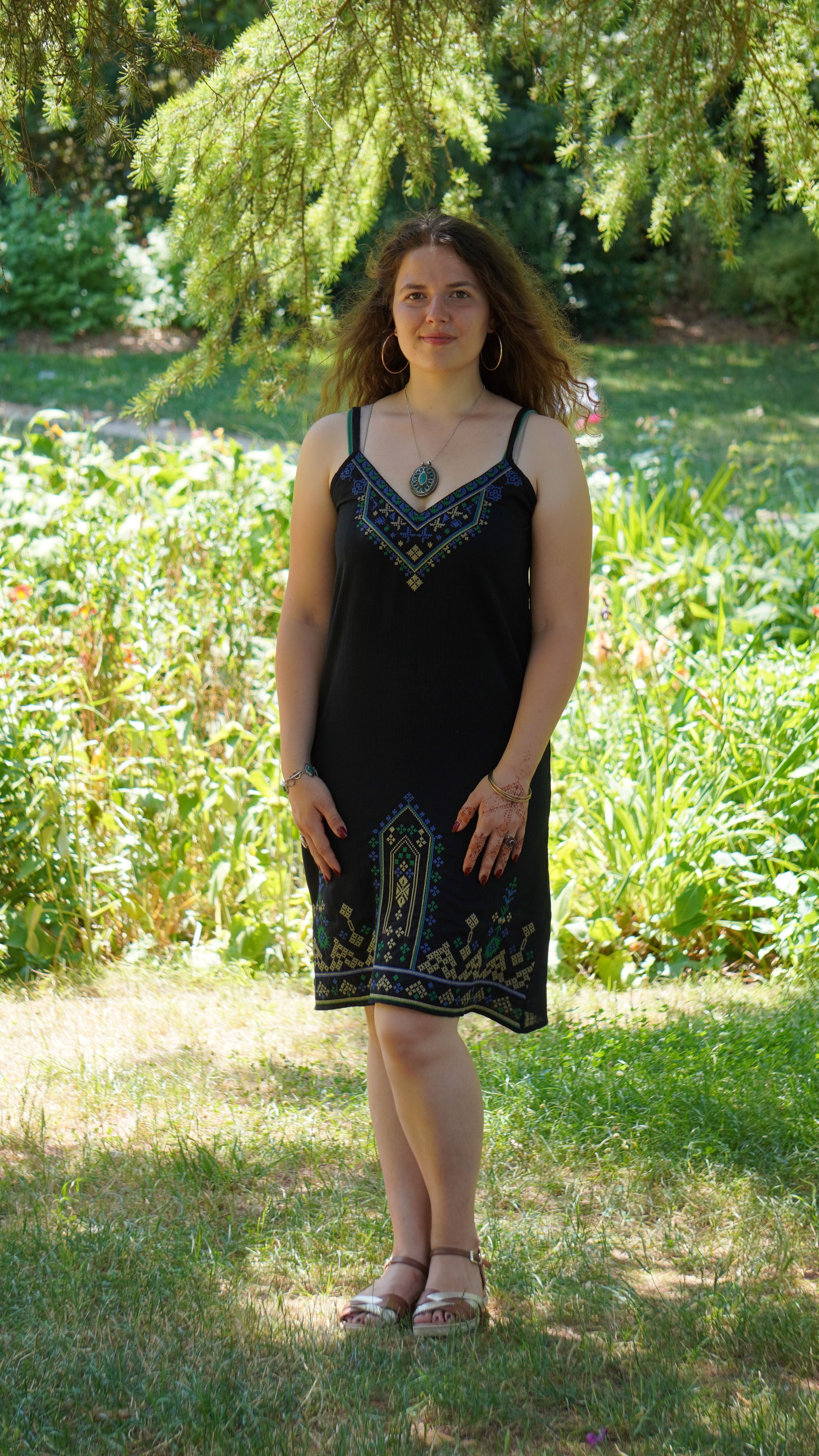 Black dress with blue, green and gold embroidery