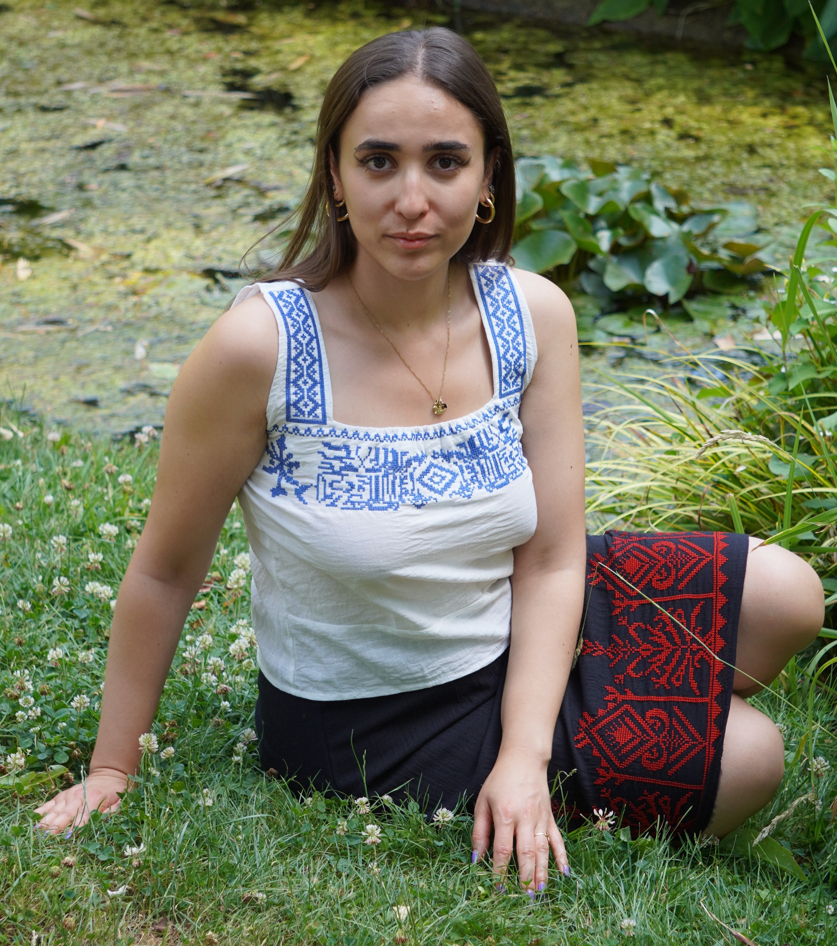White crop top with blue embroidery