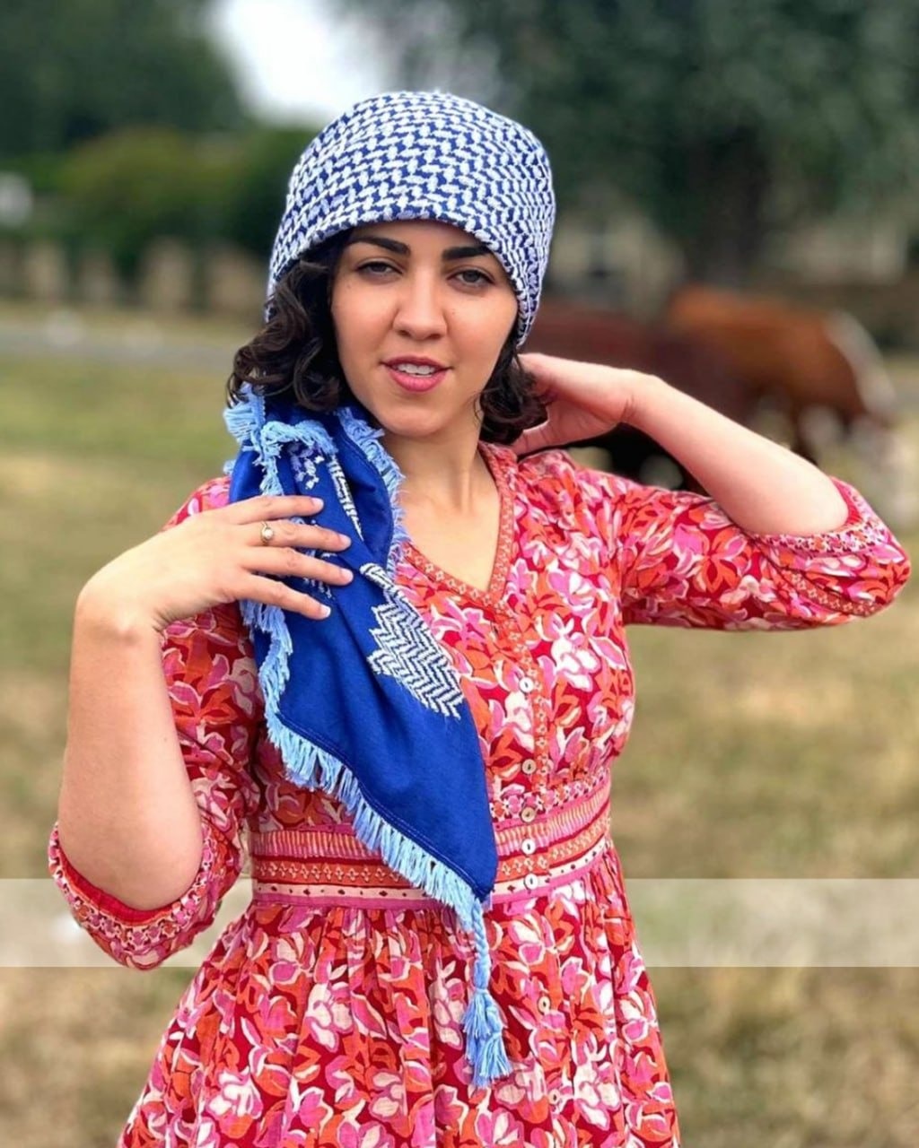 Group wearing Levami creations in a plant-filled garden.